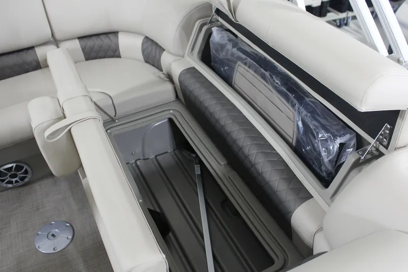 Slide: The Image of 2025 Sun Tracker Party Barge 20 DLX interior storage compartment with cushioned seating. - 17