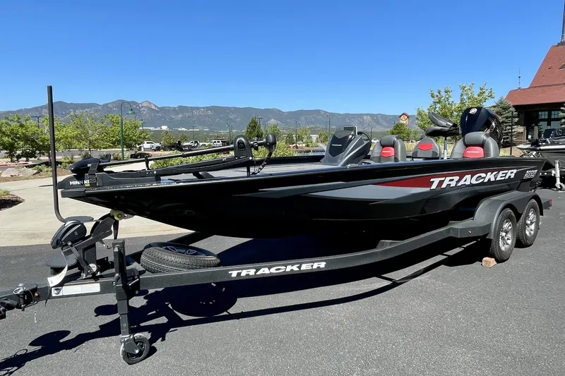 The Image of 2025 Tracker Savage 215 boat on trailer, parked outdoors with scenic mountain backdrop. - 0