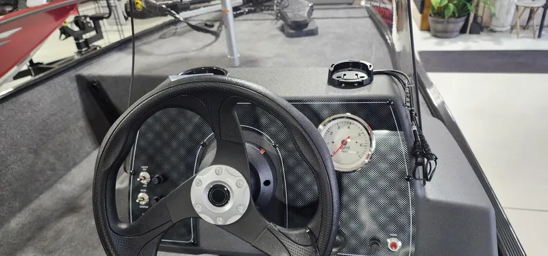 Slide: The Image of 2025 Tracker Bass Tracker Classic XL dashboard with steering wheel and RPM gauge. - 10