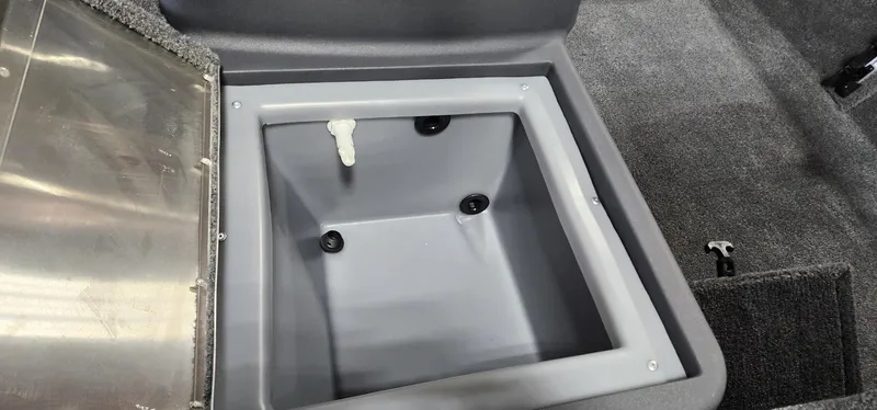 Slide: The Image of 2025 Tracker Bass Tracker Classic XL livewell interior with gray finish and drainage system. - 9