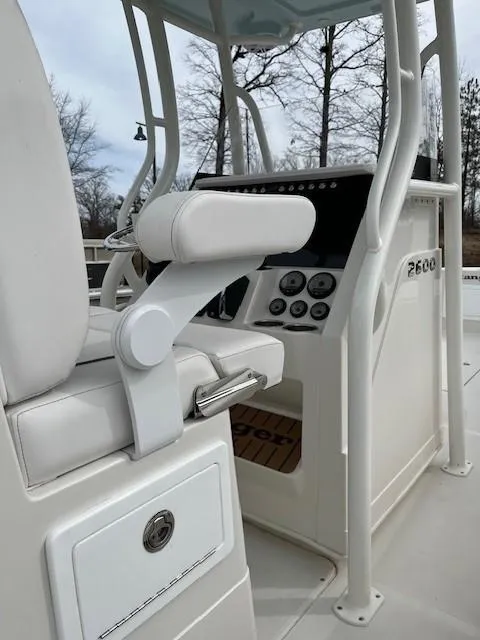 Slide: The Image of 2025 Ranger 2600 Bay boat interior with white seating and control panel. - 3