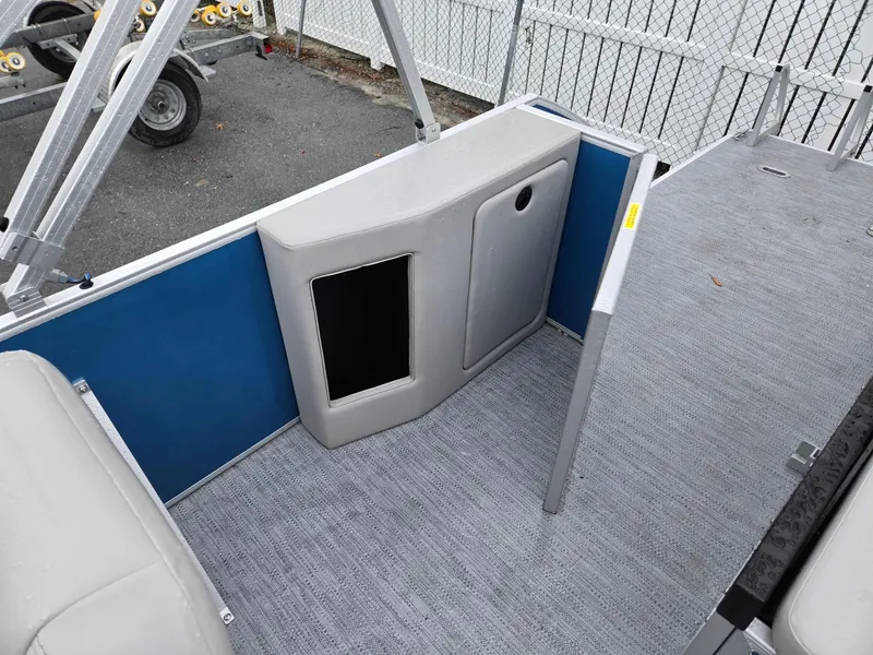 Slide: The Image of 2025 Godfrey Xperience 2286 SFLX boat interior with blue panel and gray flooring. - 15