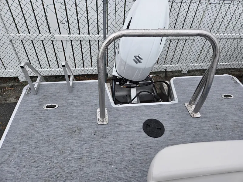 Slide: The Image of 2025 Godfrey Xperience 2286 SFLX boat deck with Suzuki outboard motor. - 17