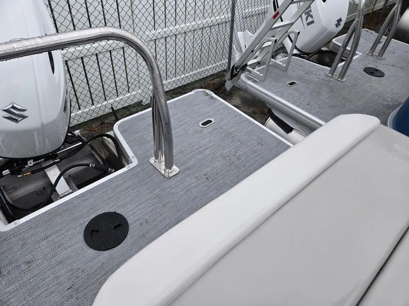 Slide: The Image of 2025 Godfrey Xperience 2286 SFLX boat deck with Suzuki outboard motor. - 18