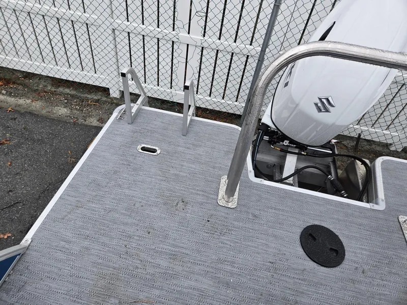 Slide: The Image of 2025 Godfrey Xperience 2286 SFLX boat deck with Suzuki outboard motor and ladder. - 19