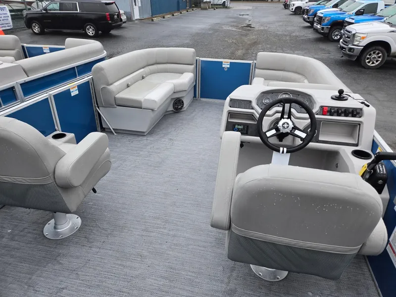 Slide: The Image of 2025 Godfrey Xperience 2286 SFLX pontoon boat interior with gray seating and steering console. - 22