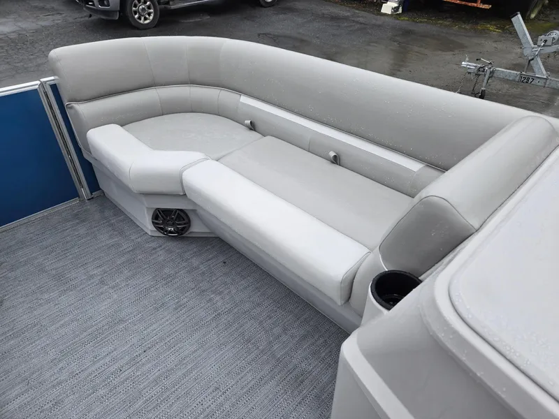 Slide: The Image of 2025 Godfrey Xperience 2286 SFLX boat interior with gray seating and cup holder. - 28