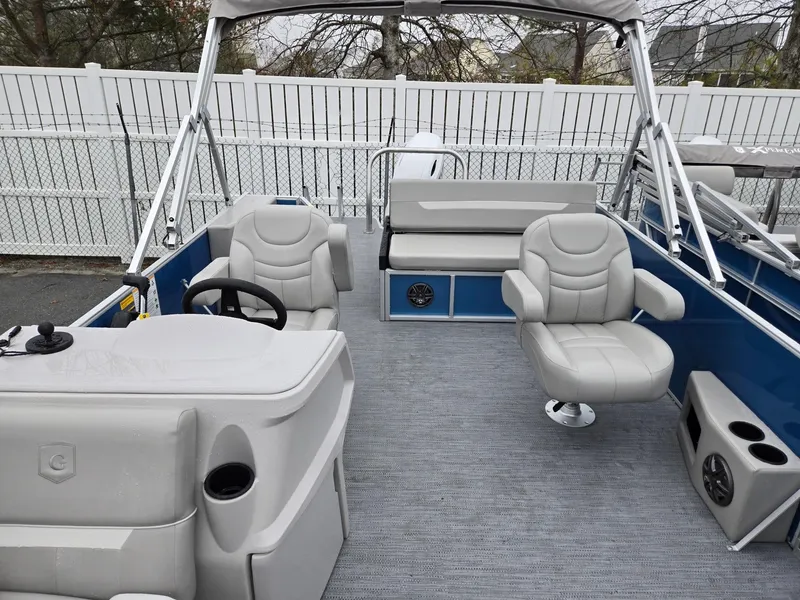 Slide: The Image of 2025 Godfrey Xperience 2286 SFLX pontoon boat interior with gray seating and steering console. - 5