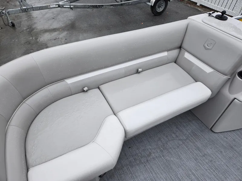 Slide: The Image of 2025 Godfrey Xperience 2286 SFLX boat interior with light gray seating and carpeted floor. - 6