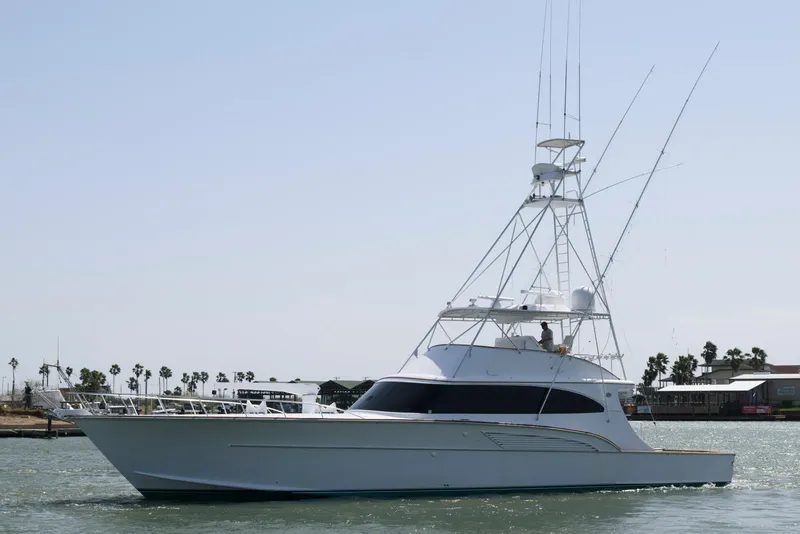 The Image of 1998 Huckins 70 Sportfish Convertible yacht on water, side view, clear sky background. - 0
