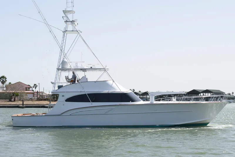 Slide: The Image of 1998 Huckins 70 Sportfish Convertible yacht on water, side view. - 1