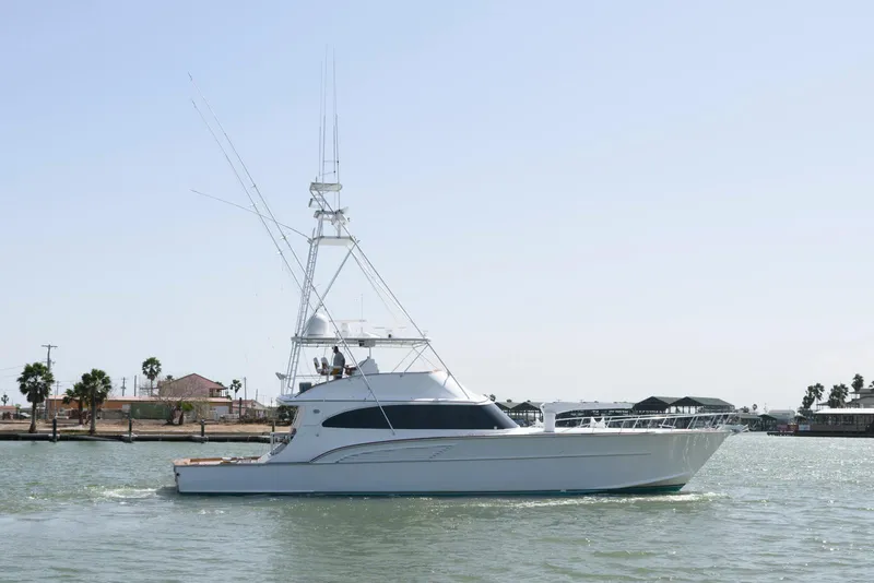 Slide: The Image of 1998 Huckins 70 Sportfish Convertible yacht cruising on calm waters. - 11