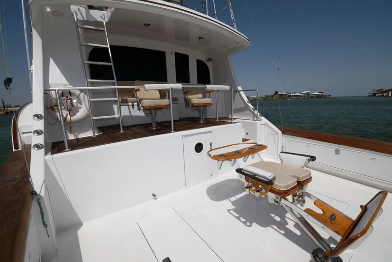 Slide: The Image of 1998 Huckins 70 Sportfish Convertible yacht deck with fishing chairs and ocean view. - 14