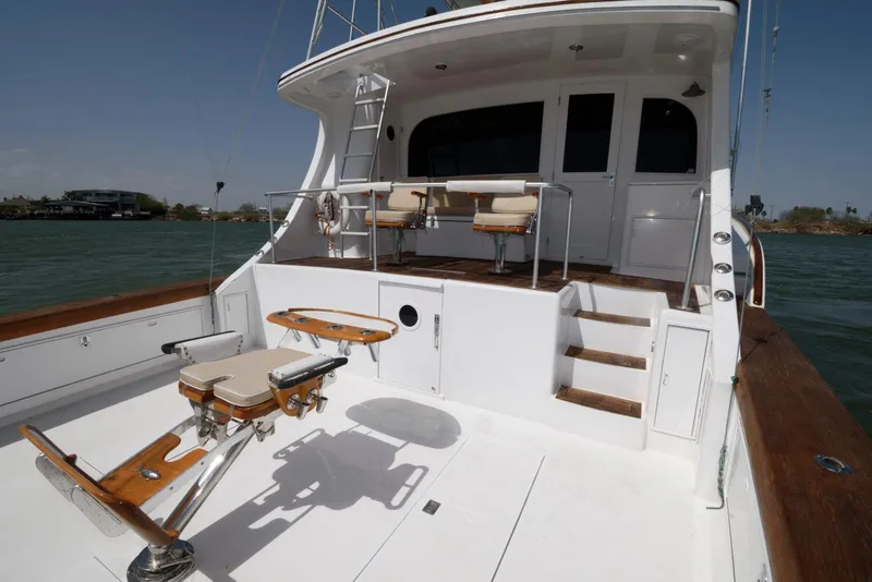 Slide: The Image of 1998 Huckins 70 Sportfish Convertible yacht with spacious deck and fishing chair. - 15