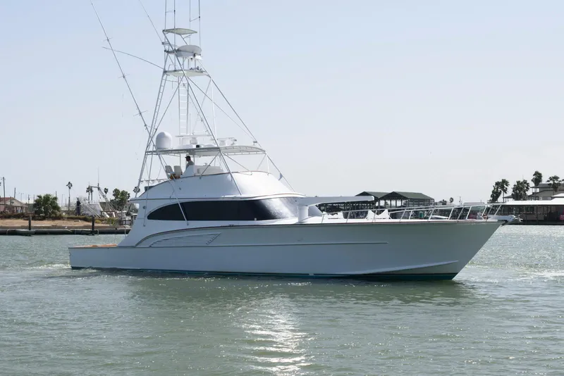 Slide: The Image of 1998 Huckins 70 Sportfish Convertible yacht on calm water. - 2