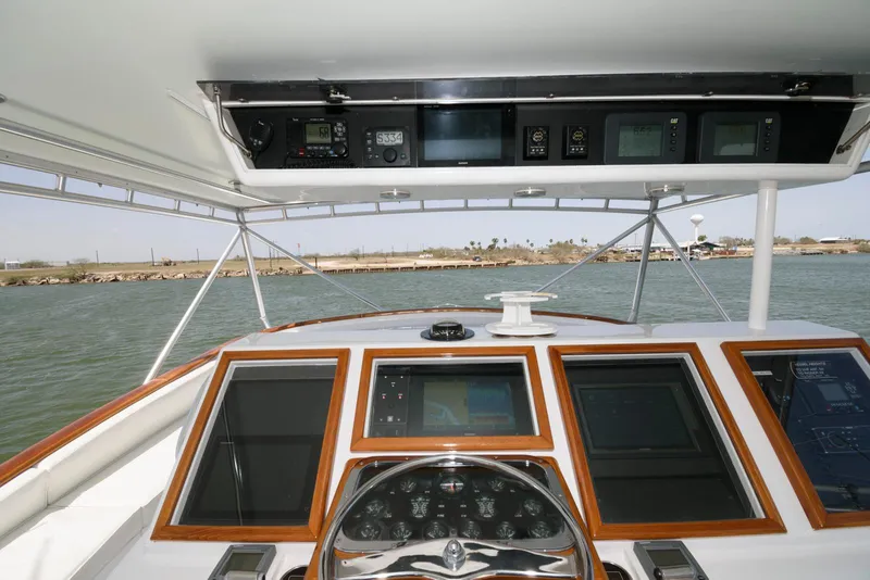 Slide: The Image of Cockpit view of 1998 Huckins 70 Sportfish Convertible yacht with navigation instruments. - 26