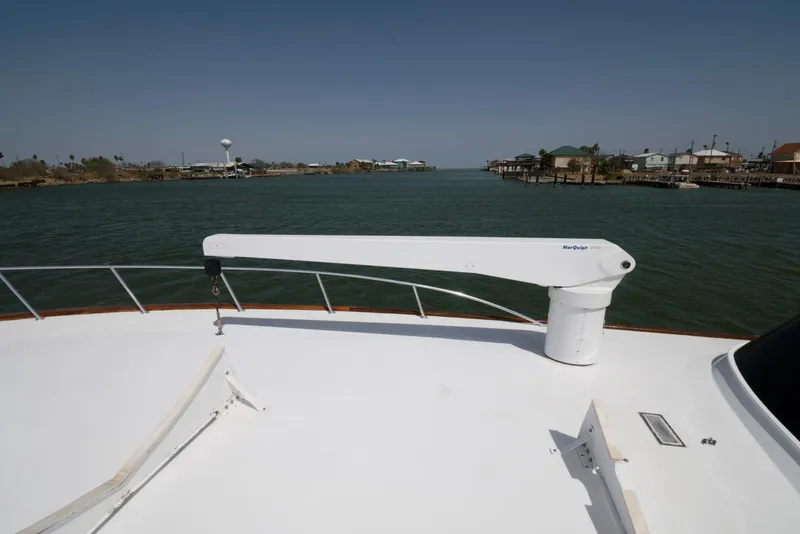 Slide: The Image of 1998 Huckins 70 Sportfish Convertible yacht deck with scenic waterway view. - 27