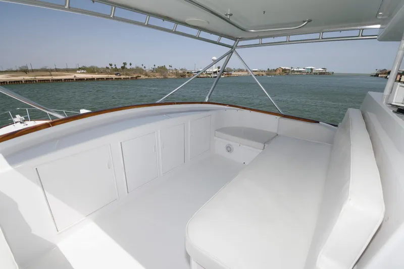 Slide: The Image of 1998 Huckins 70 Sportfish Convertible yacht interior with white seating and ocean view. - 29