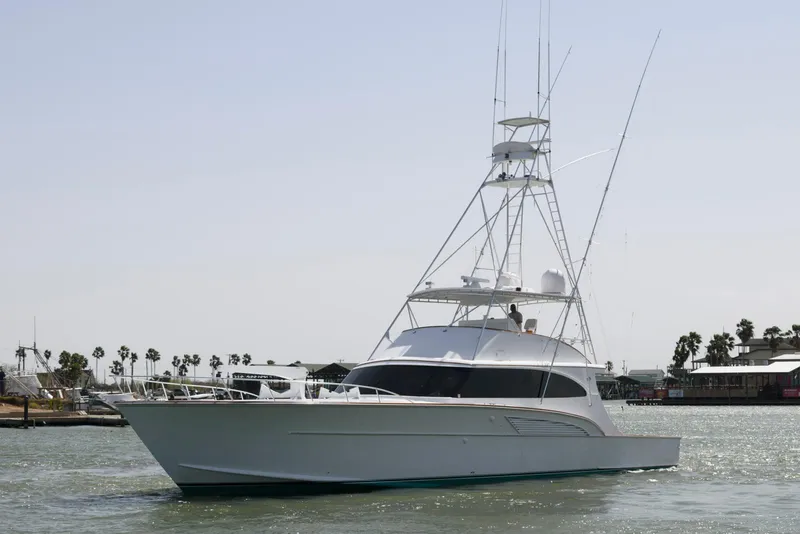 Slide: The Image of 1998 Huckins 70 Sportfish Convertible yacht on water, showcasing sleek design and fishing capabilities. - 3