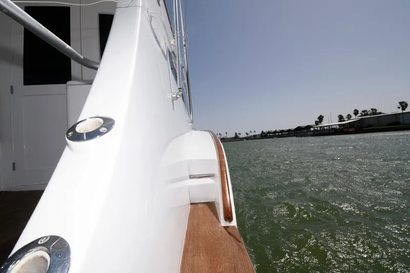 Slide: The Image of Side view of 1998 Huckins 70 Sportfish Convertible yacht on water. - 32