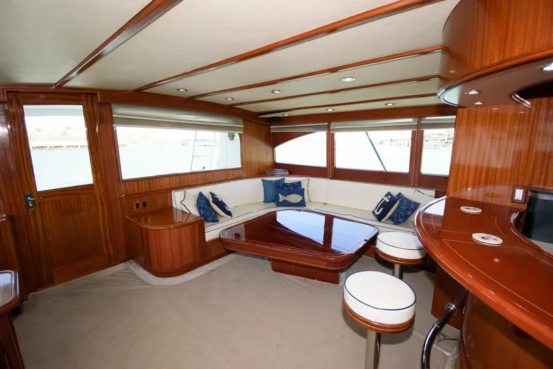 Slide: The Image of Luxurious interior of 1998 Huckins 70 Sportfish Convertible yacht with wood finish and seating area. - 36