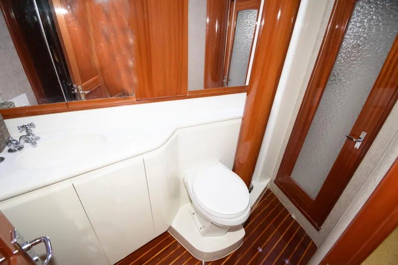 Slide: The Image of Luxurious bathroom in 1998 Huckins 70 Sportfish Convertible yacht with wood accents and modern fixtures. - 46