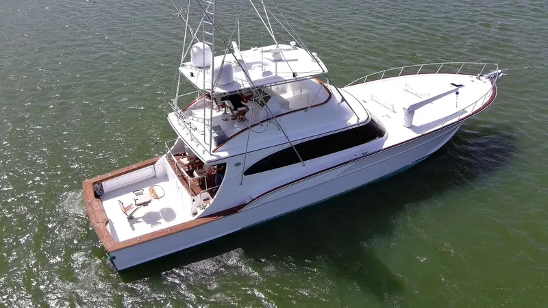 Slide: The Image of 1998 Huckins 70 Sportfish Convertible yacht cruising on open water. - 5