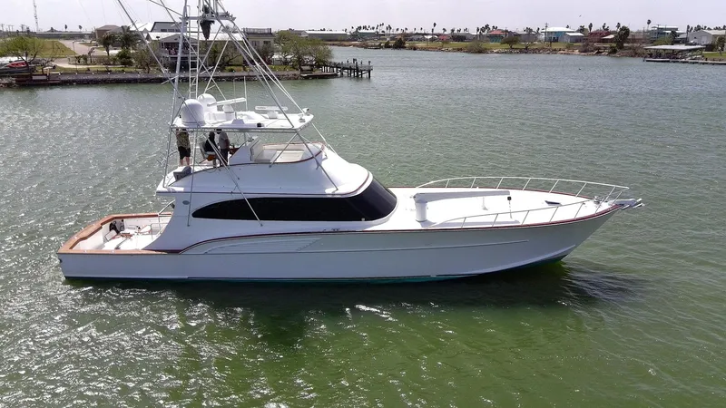 Slide: The Image of 1998 Huckins 70 Sportfish Convertible yacht on calm water, side view. - 7