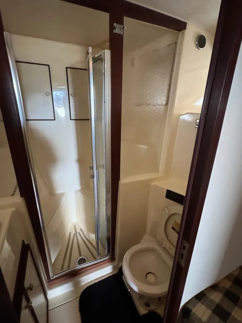 Slide: The Image of 1984 Hatteras 46 Convertible yacht bathroom with shower and toilet. - 15
