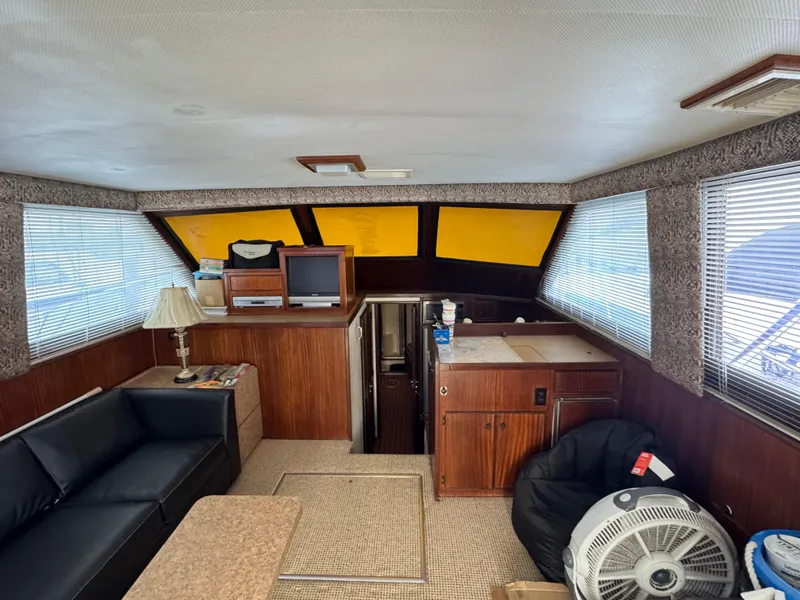Slide: The Image of Interior of 1984 Hatteras 46 Convertible yacht with seating, TV, and fan. - 19