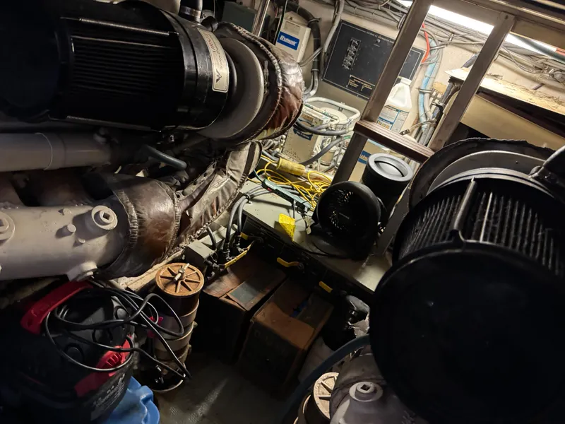 Slide: The Image of Engine room of a 1984 Hatteras 46 Convertible boat, showcasing machinery and equipment. - 28