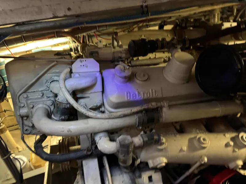 Slide: The Image of Engine room of a 1984 Hatteras 46 Convertible boat, featuring a Detroit engine. - 30
