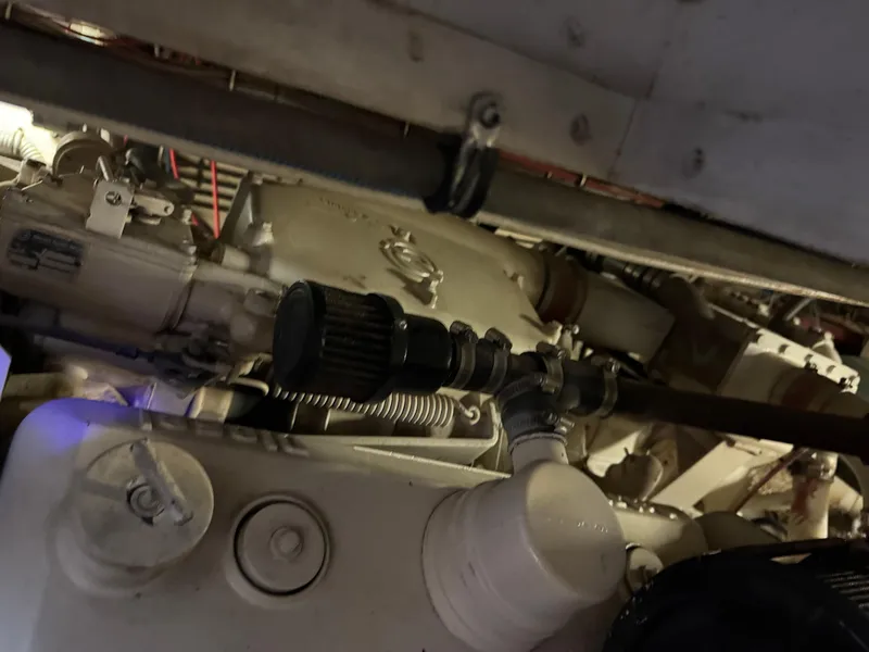 Slide: The Image of Engine compartment of a 1984 Hatteras 46 Convertible boat, showcasing mechanical components. - 31