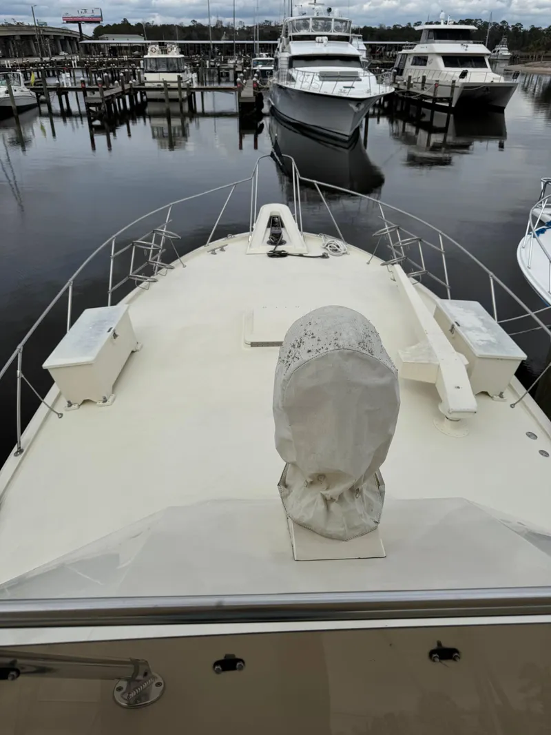 Slide: The Image of 1984 Hatteras 46 Convertible yacht docked at marina, view from bow. - 4