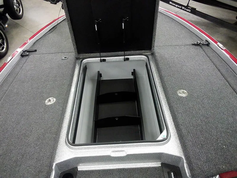 Slide: The Image of 2025 Triton 20XP Patriot boat storage compartment, open lid, spacious interior. - 12