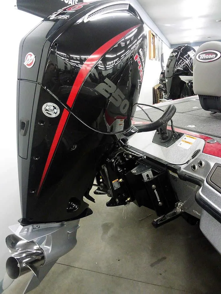Slide: The Image of 2025 Triton 20XP Patriot boat engine, sleek black design with red accents. - 2