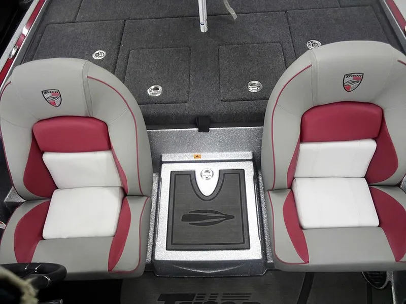Slide: The Image of 2025 Triton 20XP Patriot boat seats with red and gray upholstery. - 21