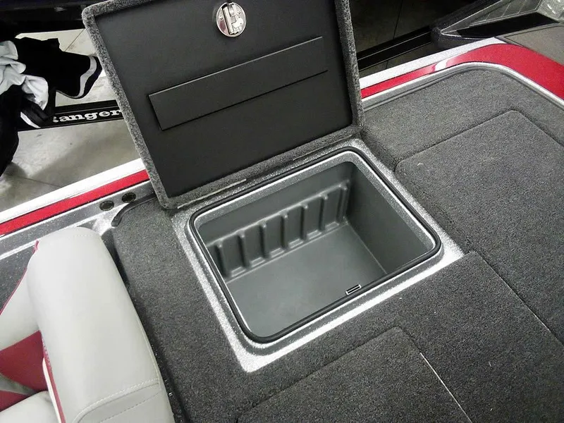 Slide: The Image of 2025 Triton 20XP Patriot boat storage compartment with open lid, showcasing interior space. - 25