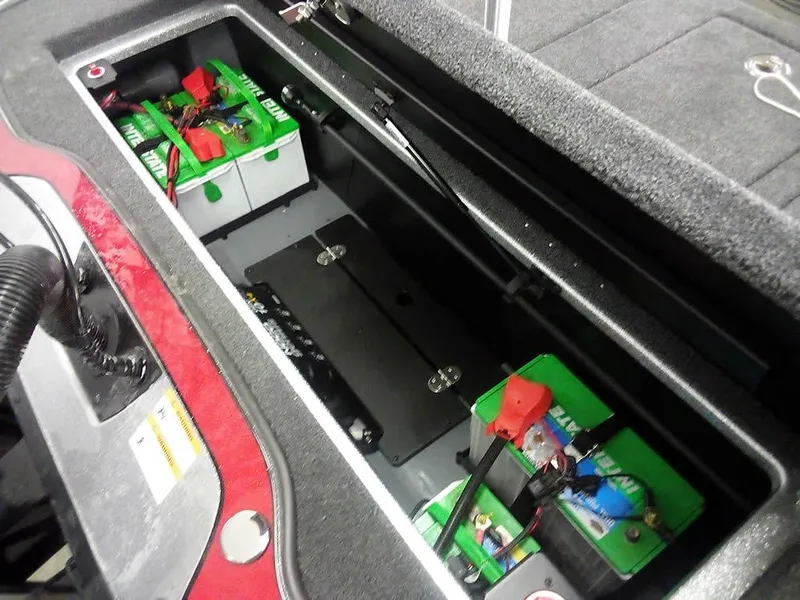 Slide: The Image of Battery compartment of 2025 Triton 20XP Patriot boat, featuring multiple green batteries. - 27