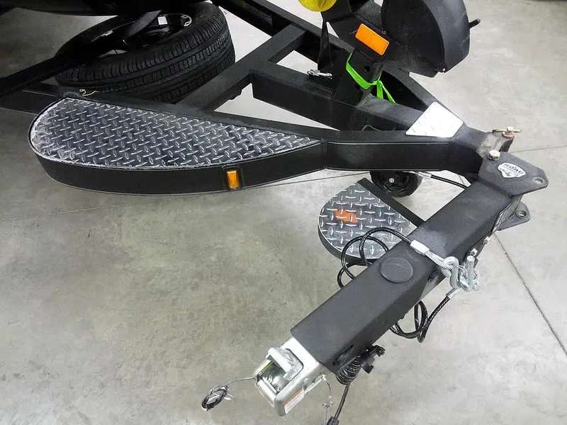 Slide: The Image of Trailer hitch of 2025 Triton 20XP Patriot with diamond plate step and safety chains. - 5