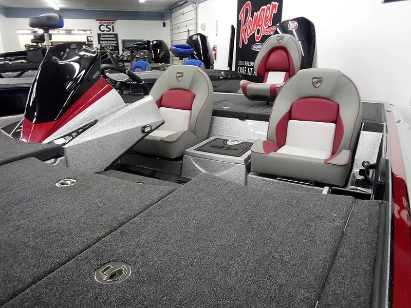 Slide: The Image of 2025 Triton 20XP Patriot boat interior with red and gray seating. - 9