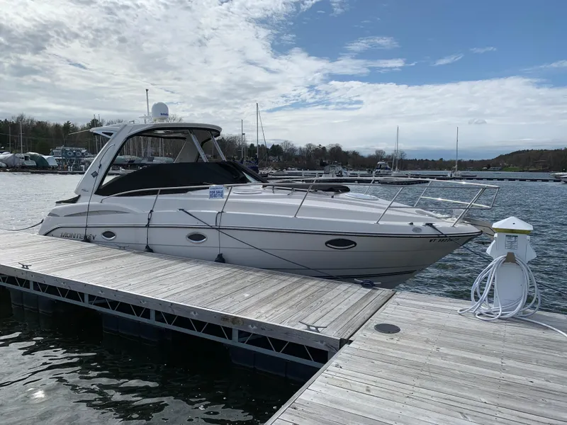 Slide: The Image of 2014 Monterey 320 Sport Yacht docked at marina under cloudy sky. - 10
