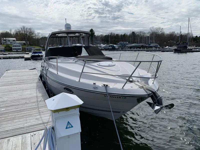 Slide: The Image of 2014 Monterey 320 Sport Yacht docked at marina under cloudy sky. - 11