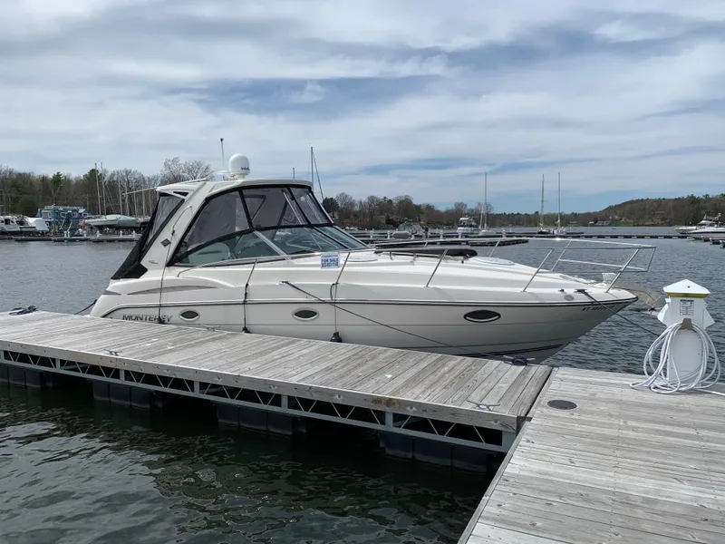 Slide: The Image of 2014 Monterey 320 Sport Yacht docked at marina under cloudy sky. - 13
