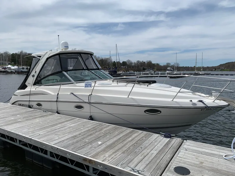 Slide: The Image of 2014 Monterey 320 Sport Yacht docked at marina under cloudy sky. - 14
