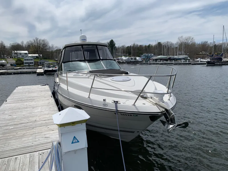 Slide: The Image of 2014 Monterey 320 Sport Yacht docked at a marina on a cloudy day. - 15