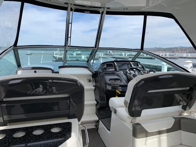 Slide: The Image of 2014 Monterey 320 Sport Yacht interior with helm, seating, and panoramic windows. - 16