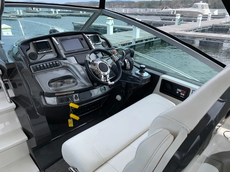 Slide: The Image of 2014 Monterey 320 Sport Yacht helm with modern controls and waterfront view. - 17