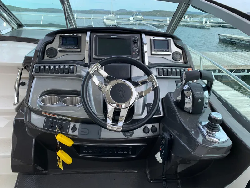Slide: The Image of Cockpit of 2014 Monterey 320 Sport Yacht with modern controls and steering wheel. - 18