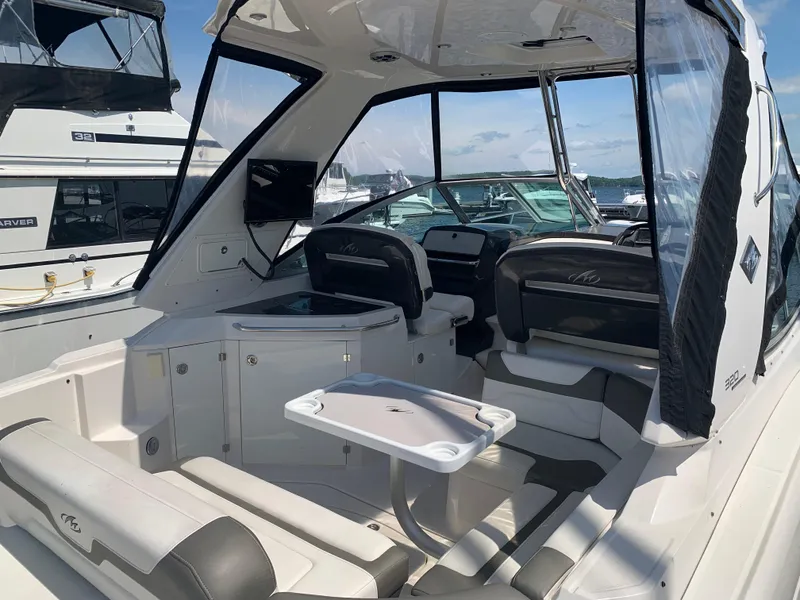 Slide: The Image of 2014 Monterey 320 Sport Yacht interior with seating, table, and clear canopy. - 2